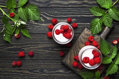 Taze berry ve yoğurt vintage ahşap mutfak masa arka planda, düz yatıyordu, en iyi görünümü ile cam kavanozlara ahududu güler yüzlü