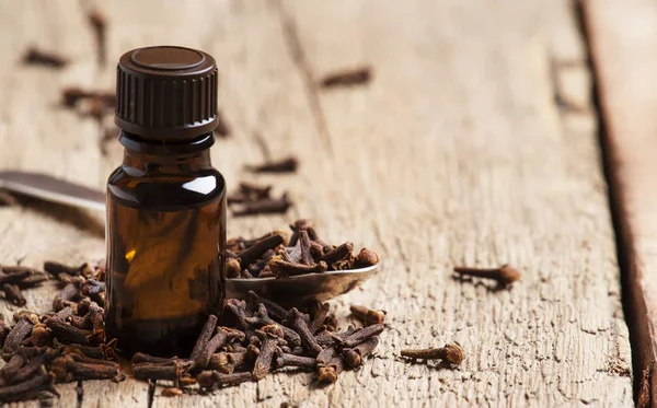 Essential Oil Cloves Brown Bottle Old Wooden Background Selective Focus — Stock Photo, Image