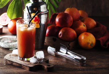 Ferahlatıcı düşük alkollü kokteyl votka, portakal suyu, kanlı turuncu ile yaz ve buz küpleri. Ahşap masa. Seçici odak. Kopya alanı