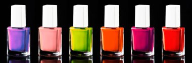 Nail polish bright neon colors from red to ultraviolet, isolated on black, banner clipart
