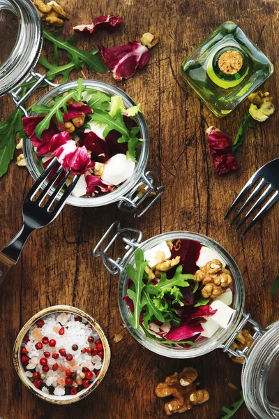 Beet salad with fresh arugula, soft goat cheese and walnuts, trendy salad jar, steel fork, gray kitchen table background, wooden cutting board, copy space, top view — Stock Image Beet Salad Fresh Arugula Soft Goat Cheese Walnuts Trendy Salad Royalty Free Stock Photos