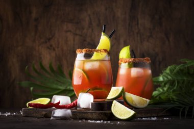 Michelada - Bira, limon suyu, domates suyu, baharatlı sos ve baharatlar, vintage ahşap arka plan, seçici odak ile Meksika alkollü kokteyl