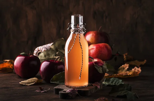 Apple vinegar. Bottle of apple organic vinegar made from fermented apples on wooden background. Healthy organic food.