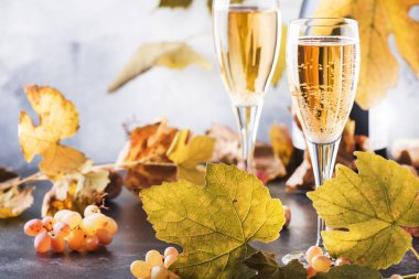 Champagne wine in glass background. Autumn still life, wine tasting table setting concept clipart