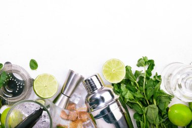 Mojito cocktail alcohol long drink making. Mint, lime, ice, white rum, cane sugar ingredients and bar utensils. Top view, white table background. Flat lay clipart