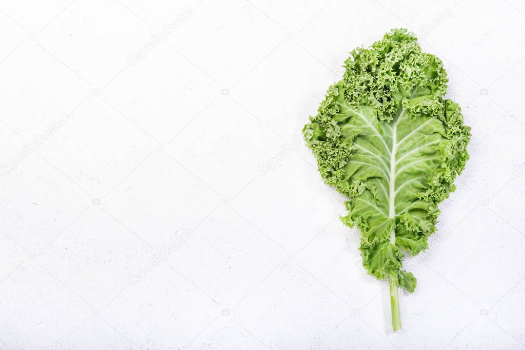 Kale cabbage. Green vegetable leaves, top view on white background, healthy eating, vegetarian food