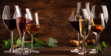 Wine tasting concept, still and sparkling wines. Red, white wine, rose and champagne in wine glasses. Panoramic banner with copy space clipart
