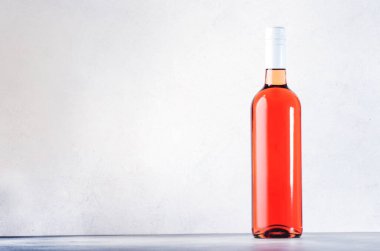 Gri masadaki gül şarabı şişesi. Pembe rosado, rosato ya da şarap tadımı, bar konsepti. Boşluğu Kopyala