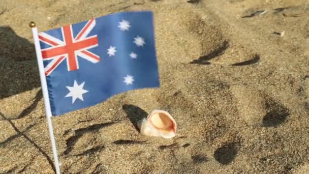 Flag of Australia on a sandy beach. — Stock Video
