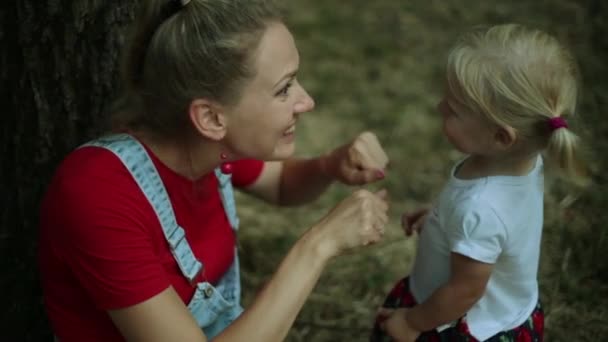 Nőt és a gyermeket a parkban játszó — Stock videók