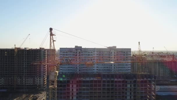 Vista aérea - construcción de grúas y ciudad . — Vídeos de Stock