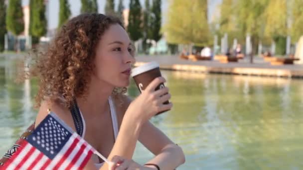 Junge Frau mit der Fahne von uns. Amerika, Tourismus, Englisch. — Stockvideo