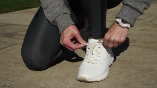 Zapatillas deportivas para mujer. Una mujer corre en el parque . — Vídeos de Stock