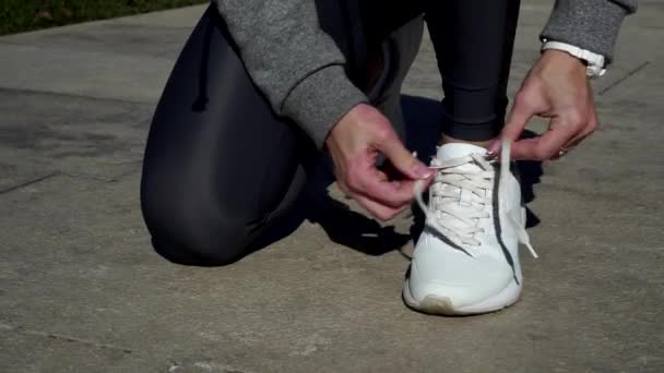 Vrouw uitgevoerd in sneakers. Het meisje gaat in voor sporten in het park. — Stockvideo