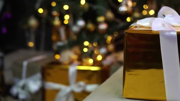 Συσκευασία δώρου σε χριστουγεννιάτικο δέντρο φόντο. Πρωτοχρονιά και τα Χριστούγεννα έννοια. — Αρχείο Βίντεο