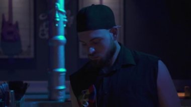 Barın arkasında bir gece kulübünde barmen.