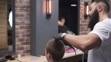 Kuaför adam istemci saç kurutmak.