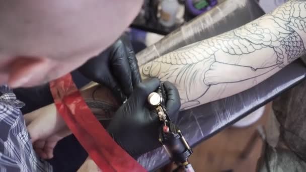 Muž dělá tetování na paži, detail. Tattooist.