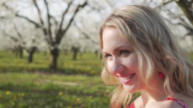 Bahar, çiçekli ağaçların arka planda bir elma ile genç bir kadının portre.