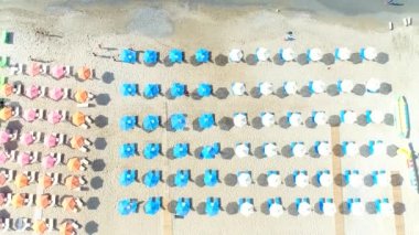 Kumlu plaj, tatil köyü, deniz kıyısı, güneşten şemsiye.