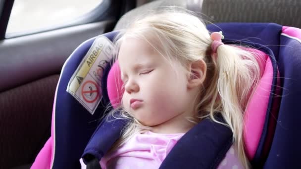 Baby Girl Rider i bilen och sover i en bilbarnstol, slow motion. — Stockvideo