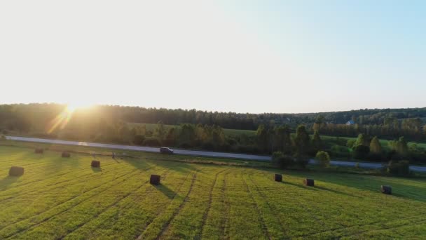 Grönt fält, höstack, solstrålarna. Landsbygden, utsikten från luften. — Stockvideo