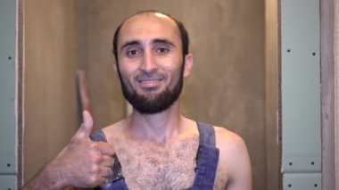 Yetişkin bir erkek işçi ya da inşaat işçisi onay veriyor