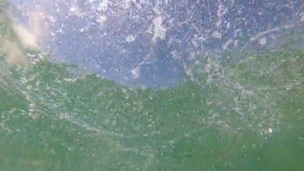 Air bubbles and sun rays on the sea surface. Air bubbles in the water — Stock Video