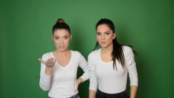 Two Beautiful Young Woman Showing Emotions Camera Green Background — Stock Video