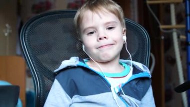 Çocuk kulaklık aracılığıyla müzik dinler. Çocuk odasında çocuk müzik hoşlanır.