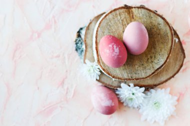 Pink, Easter eggs on a wooden stand.