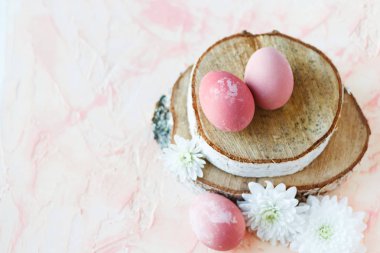 Pink, Easter eggs on a wooden stand.