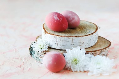 Pink, Easter eggs on a wooden stand.