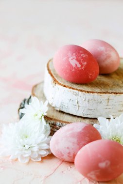 Pink, Easter eggs on a wooden stand.