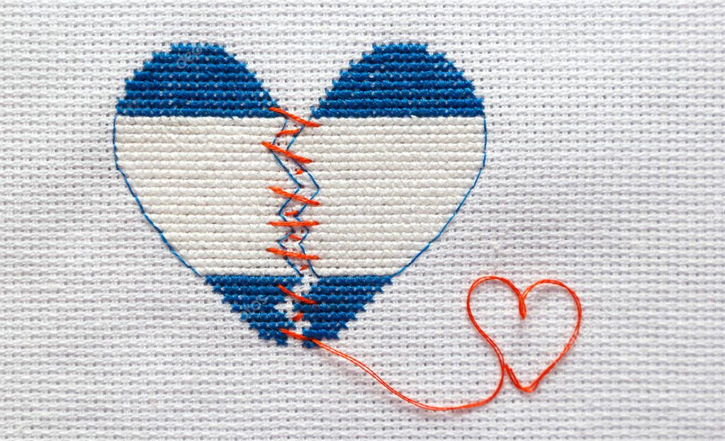 Embroider the broken heart of the colors of the flag of Israel sewed with red threads. Heart surgery.