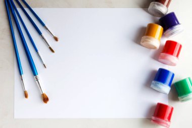 Çizim için ayarlayın. Beyaz kağıt, guaş ve fırçalar en baştan alınır.