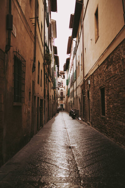 Vertical orange sun light in medieval street Italian city Bergamo.