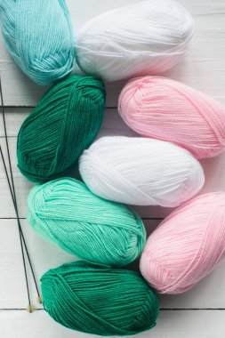 topları örgü kapatın ve beyaz ahşap zemin, pastel mavi yeşil ve beyaz renkler, en iyi görünüm düz örgü iğneleri yatıyordu, stok fotoğraf görüntü