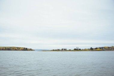 Göl, köy, orman ve gökyüzü ile sonbahar manzarası