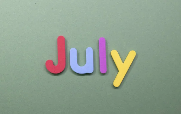 Word July written with color sponge