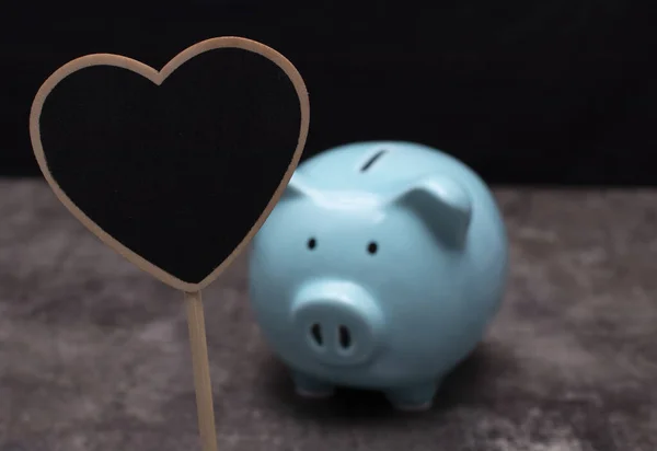 Heart shaped chalkboard with piggy bank