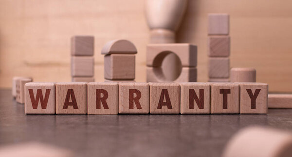Word "Warranty" written with wooden blocks