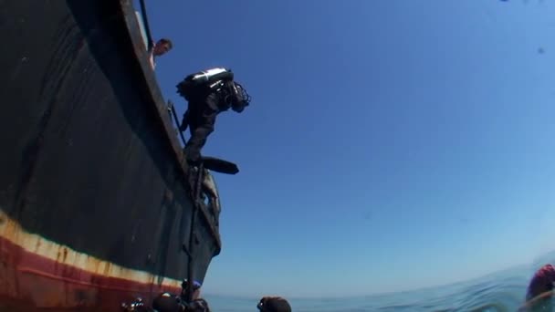 Plongeur saute dans l'eau du navire, vue du bas . — Video