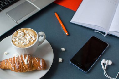 Çalışma masası, dizüstü bilgisayar, kahve ve kruvasan ile kompozisyon yaratıcı düz yatıyordu