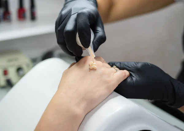 Master of manicure makes manicure to the client in the salon. Neil care. Close up