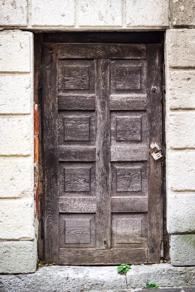 Beautiful old gate on the stone wall background. Close-up. Architecture.