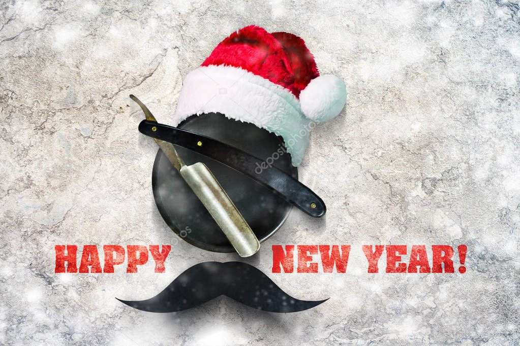 Razor on a plate for foam with a Santa Claus hat on a gray background. Inscription Happy New Year. Greeting card Happy New Year and Merry Christmas for a hairdresser and barber shop.