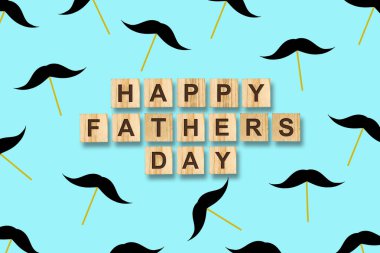 Babalar günün kutlu olsun. Bir sopa üzerinde bıyık bir sürü ve mavi bir arka plan üzerinde ahşap bloklar üzerinde yazıt. Tebrik arka plan.