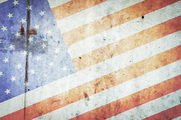 US flag on the background of a concrete wall. Independence Day America background.