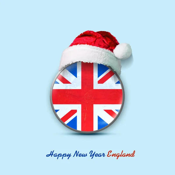 Happy New Year England. Flag of England in a round badge, and in a Santa hat. Isolated on a light blue background. Design element. Festive background.